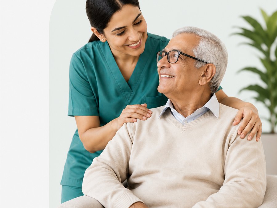 Caregiver smiling with an elderly gentleman at home